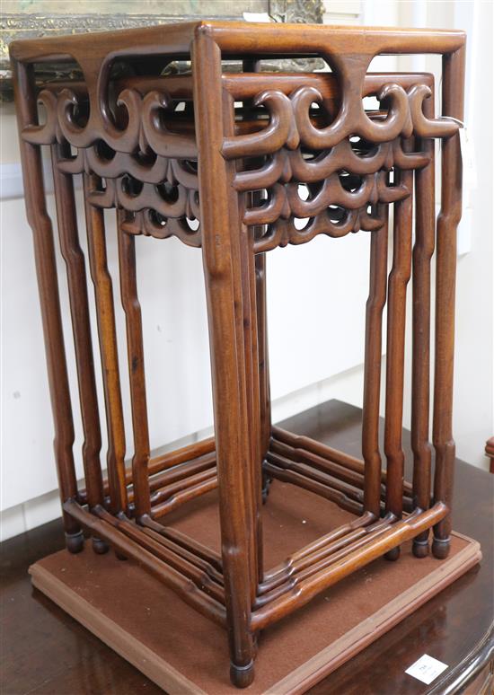 A quartetto of Chinese hardwood occasional tables, the square tops with pierced scrolled friezes